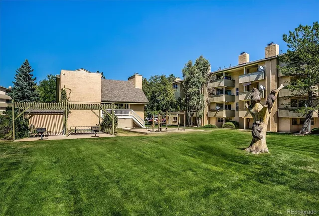 a view of a garden with a building in the background