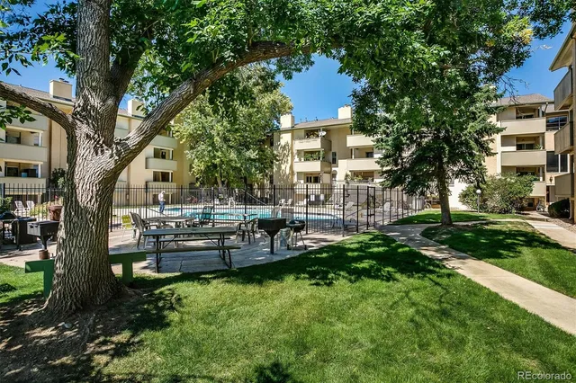 a view of a house with a yard and sitting area