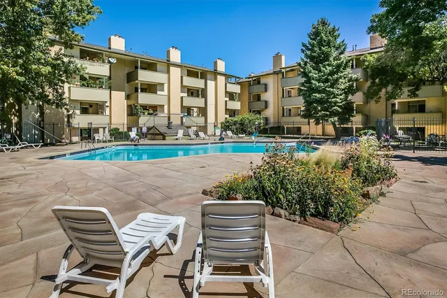 a view of a patio with a table and chairs