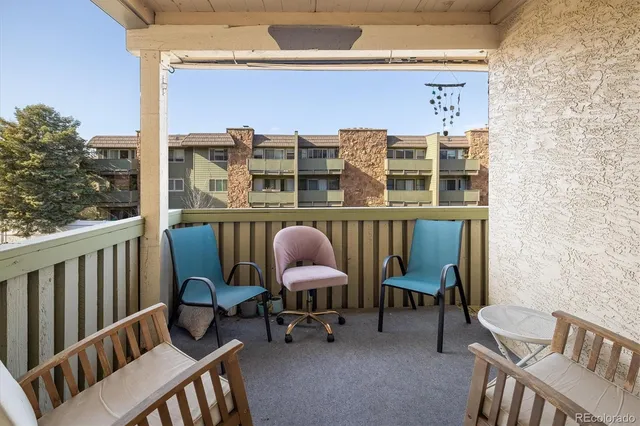 a view of a chairs and table in the balcony