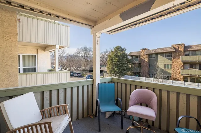 a view of a chair and table in the balcony
