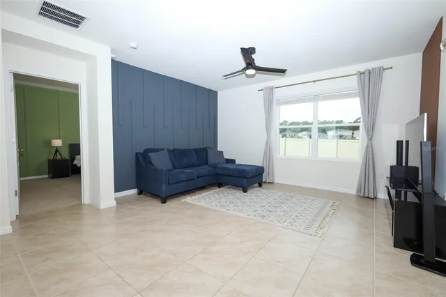 a living room with couches and a flat screen tv