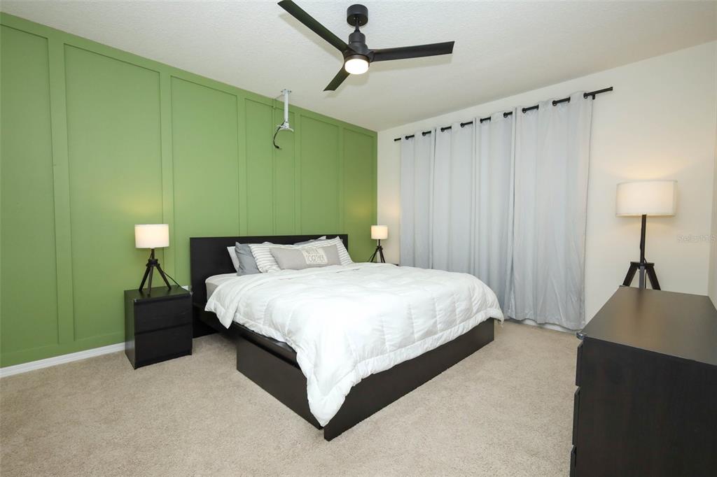 33417 Affirmed Way Sorrento, FL 32776 - Photo 14 of 43 a bedroom with a bed and a chandelier