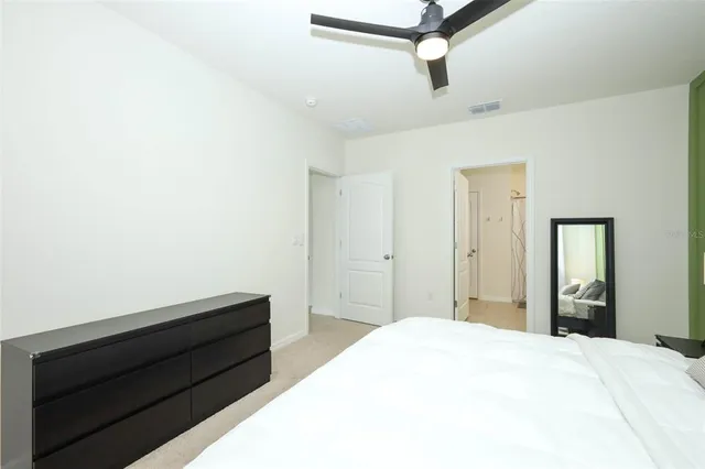 a bedroom with a bed and a dresser