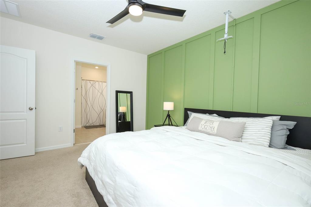 33417 Affirmed Way Sorrento, FL 32776 - Photo 17 of 43 a bedroom with a bed and a chandelier