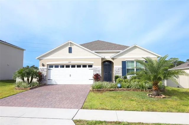 a front view of a house with a yard and garage