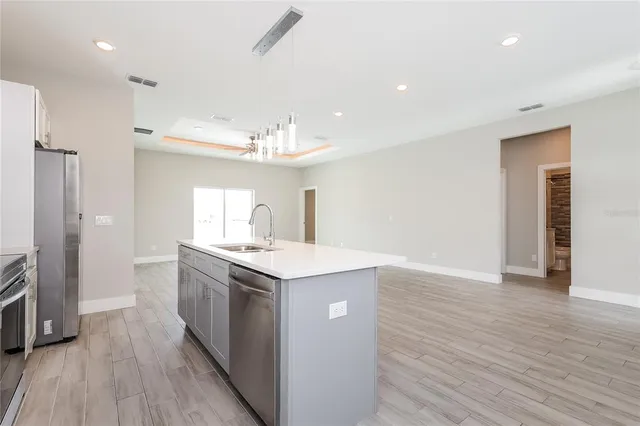 a kitchen with a sink and chandelier