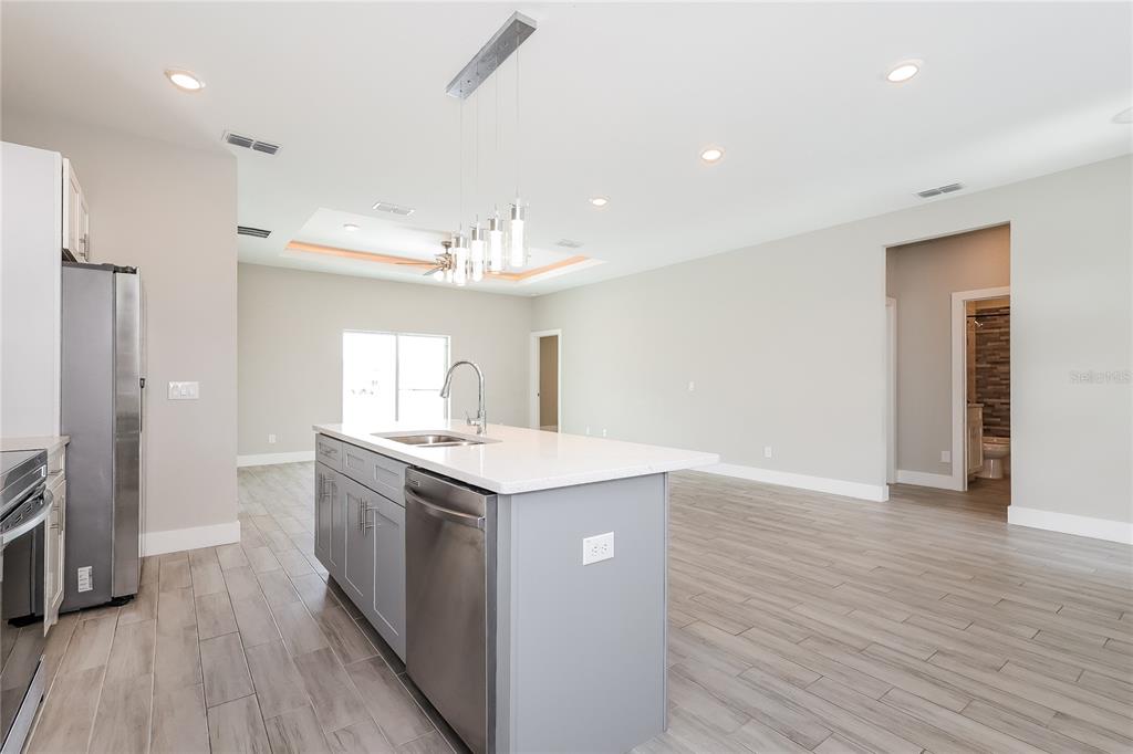 2177 Rio Grande Canyon Loop Kissimmee, FL 34759 - Photo 4 of 15 a kitchen with a sink and chandelier