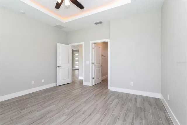 an empty room with wooden floor and closet