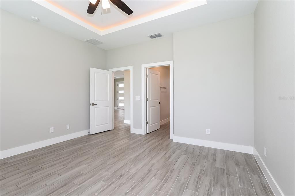 2177 Rio Grande Canyon Loop Kissimmee, FL 34759 - Photo 8 of 15 an empty room with wooden floor and closet