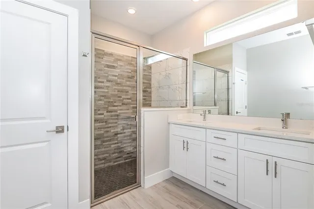 a bathroom with a double vanity sink and mirror