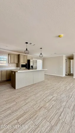 a view of a livingroom with an empty space and window
