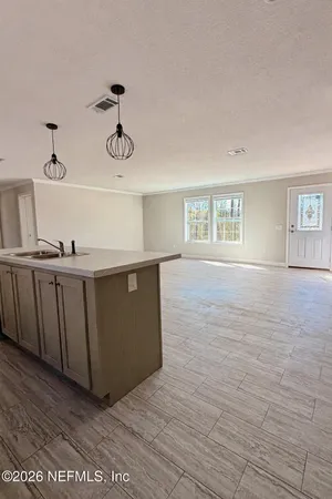 a kitchen with granite countertop a stove top oven and cabinets
