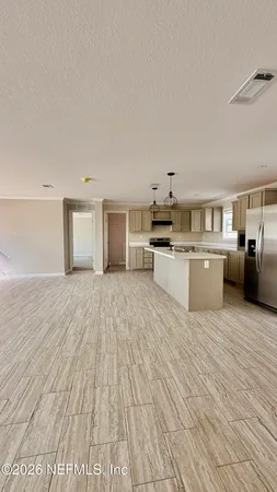 a view of a kitchen with microwave and cabinets