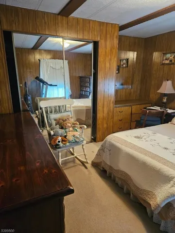 a bedroom with a bed and a mirror