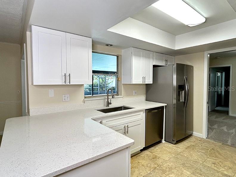 4791 Deer Road Orlando, FL 32812 - Photo 12 of 35 a kitchen with stainless steel appliances a sink stove and refrigerator