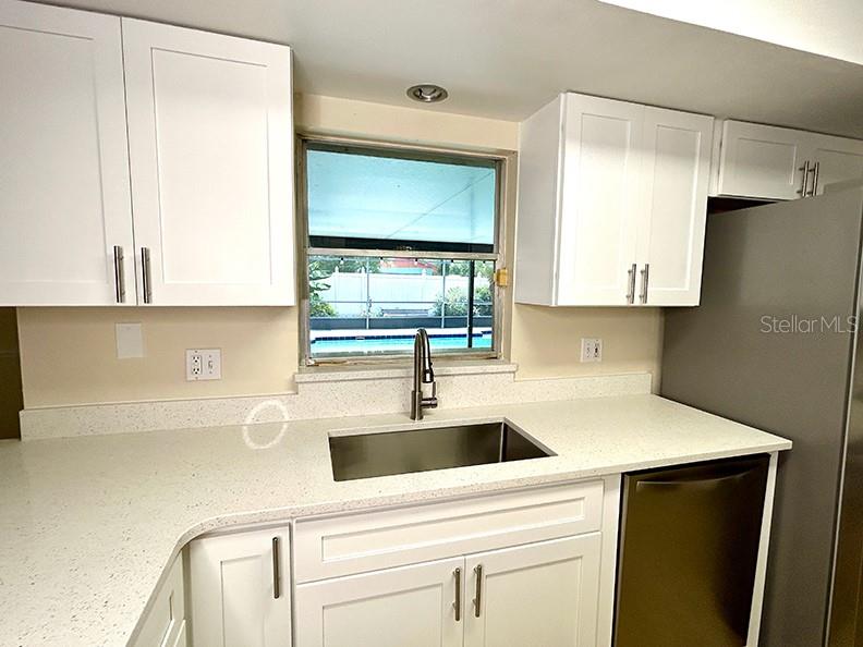 4791 Deer Road Orlando, FL 32812 - Photo 14 of 35 a kitchen with a sink and a refrigerator