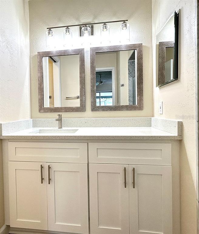 4791 Deer Road Orlando, FL 32812 - Photo 19 of 35 a bathroom with double vanity sink and a mirror