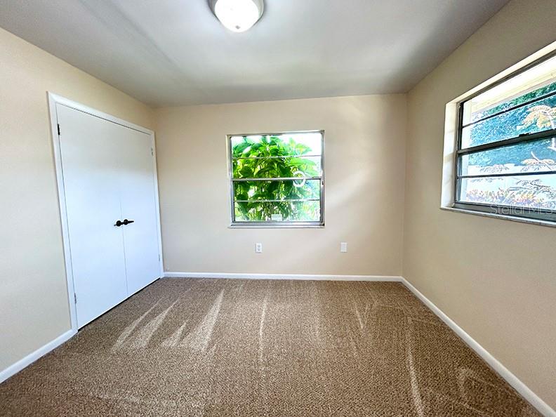 4791 Deer Road Orlando, FL 32812 - Photo 22 of 35 wooden floor in an empty room with a window