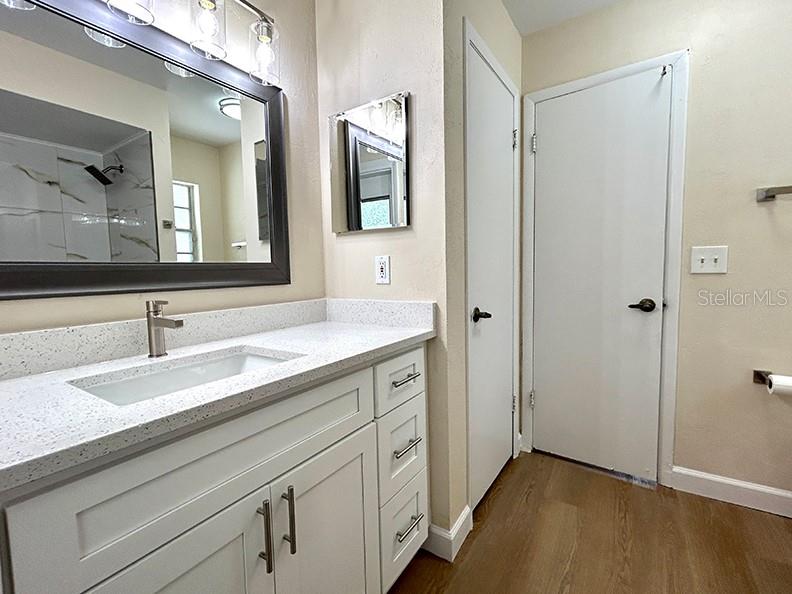 4791 Deer Road Orlando, FL 32812 - Photo 25 of 35 a spacious bathroom with a granite countertop sink and a mirror