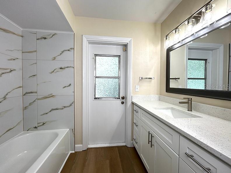 4791 Deer Road Orlando, FL 32812 - Photo 26 of 35 a bathroom with a granite countertop sink a toilet and shower