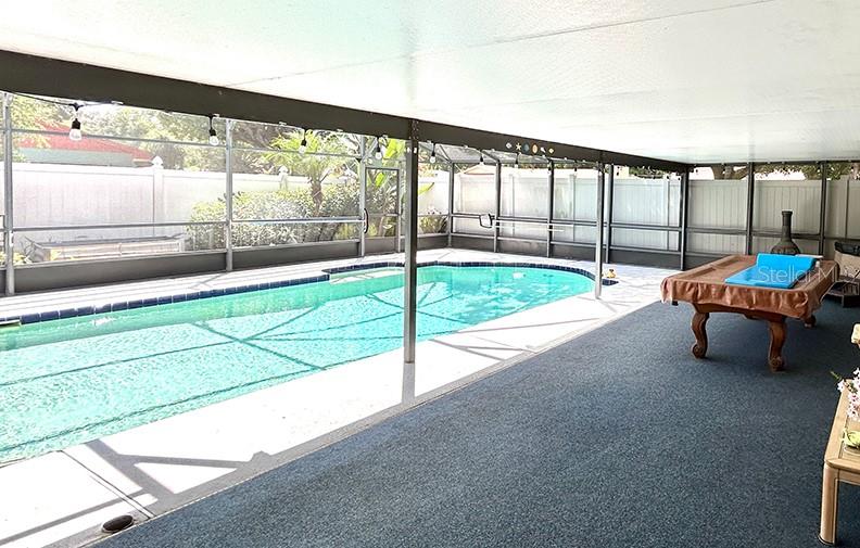 4791 Deer Road Orlando, FL 32812 - Photo 32 of 35 a living room with a bed and a table