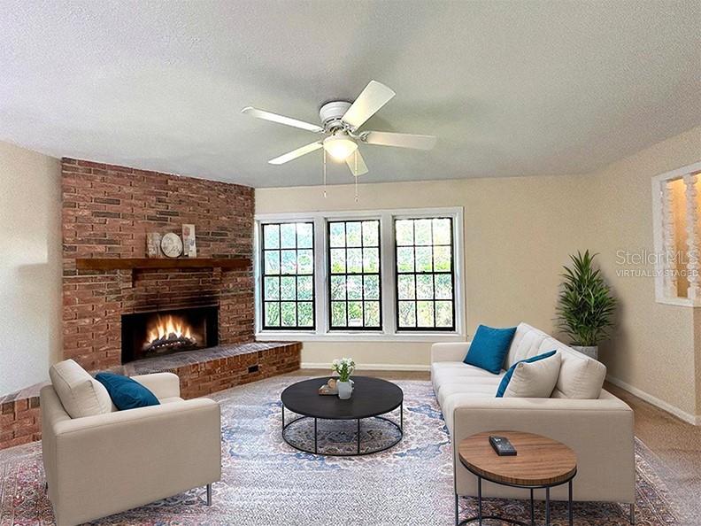 4791 Deer Road Orlando, FL 32812 - Photo 5 of 35 a living room with furniture a fireplace and a large window