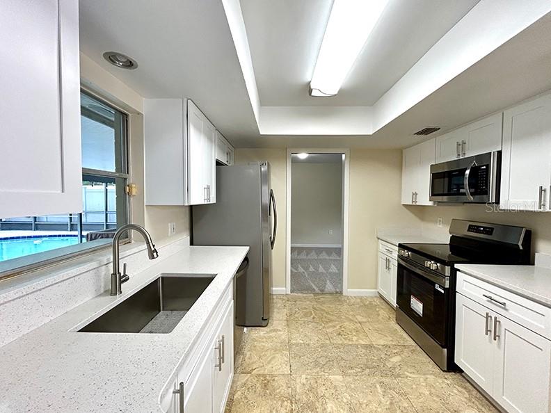 4791 Deer Road Orlando, FL 32812 - Photo 10 of 35 a kitchen with a sink stove and refrigerator