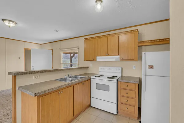 a kitchen with a stove top oven sink and cabinets