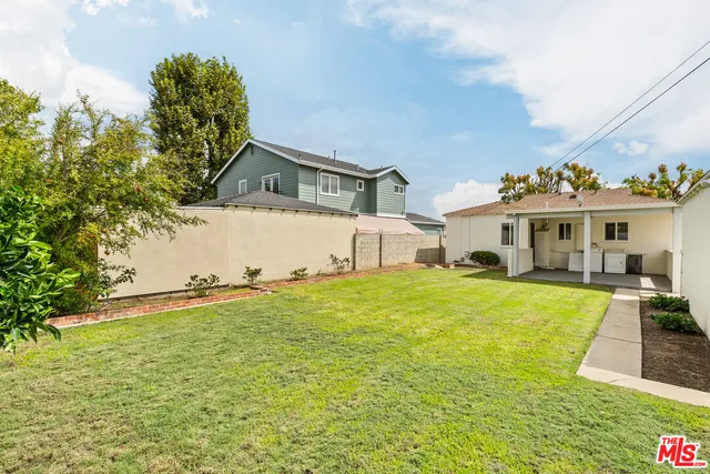 a front view of house with yard and trees