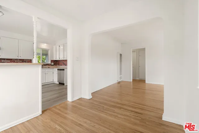 a view of a kitchen with wooden floor and a sink