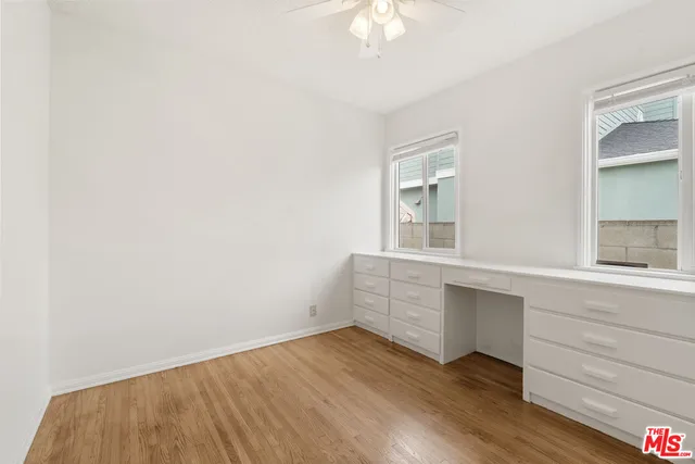 a room with a hardwood and ceiling fan