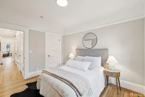 a view of a hallway with wooden floor and entryway