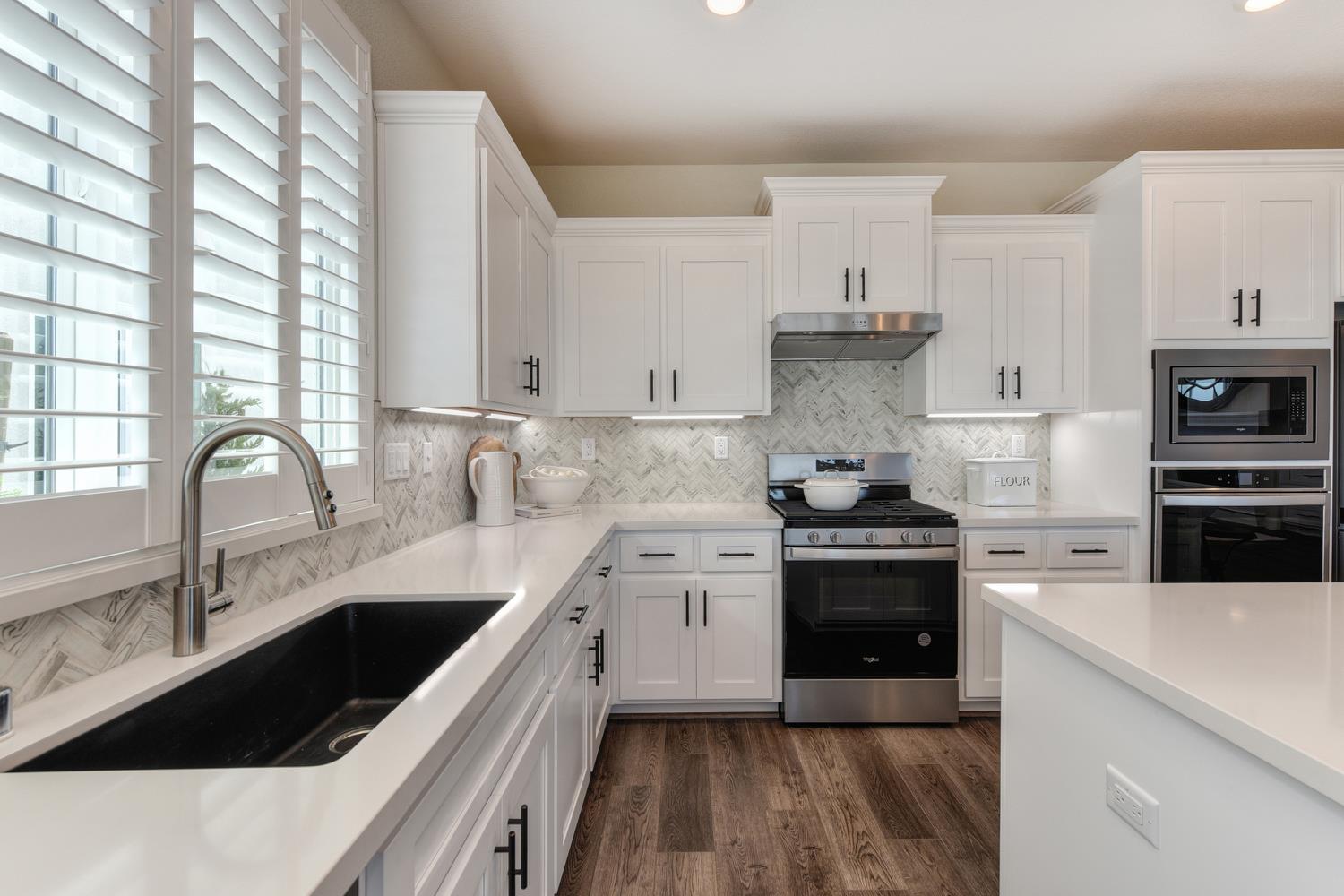 4080 Peter's Court Rocklin, CA 95765 - Photo 12 of 64 a kitchen with a sink stove and cabinets