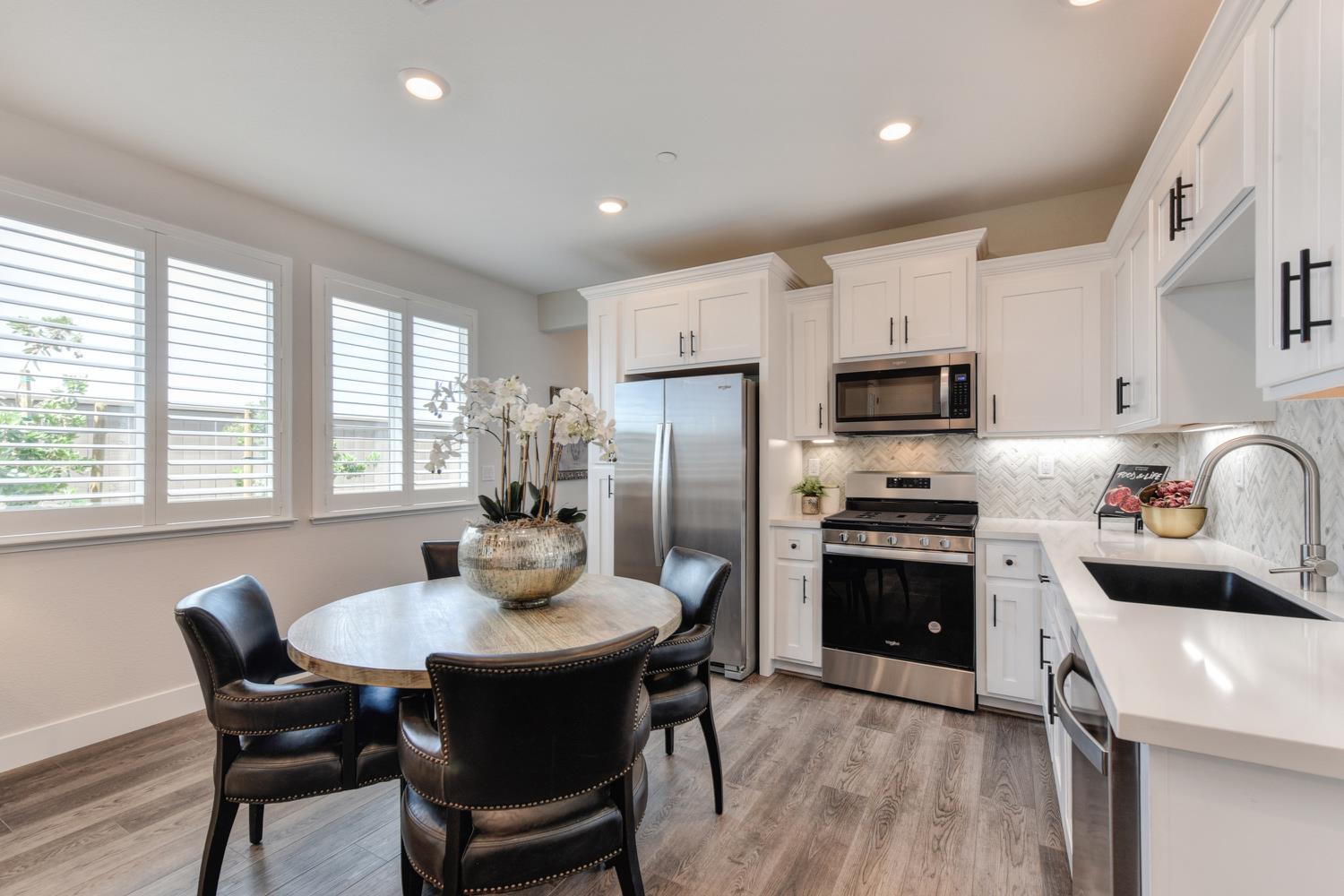 4080 Peter's Court Rocklin, CA 95765 - Photo 25 of 64 a kitchen with kitchen island a dining table and appliances