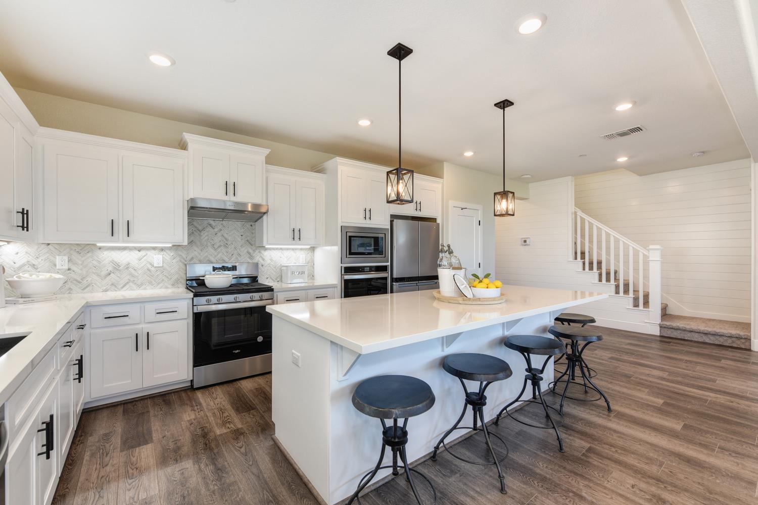 4080 Peter's Court Rocklin, CA 95765 - Photo 5 of 64 a large kitchen with granite countertop lots of counter space and wooden floor