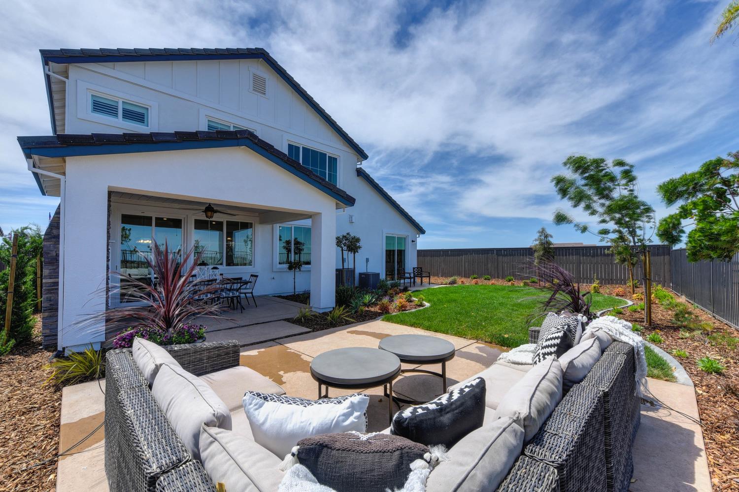 4080 Peter's Court Rocklin, CA 95765 - Photo 57 of 64 a view of a patio with couches table and chairs with potted plants and wooden fence