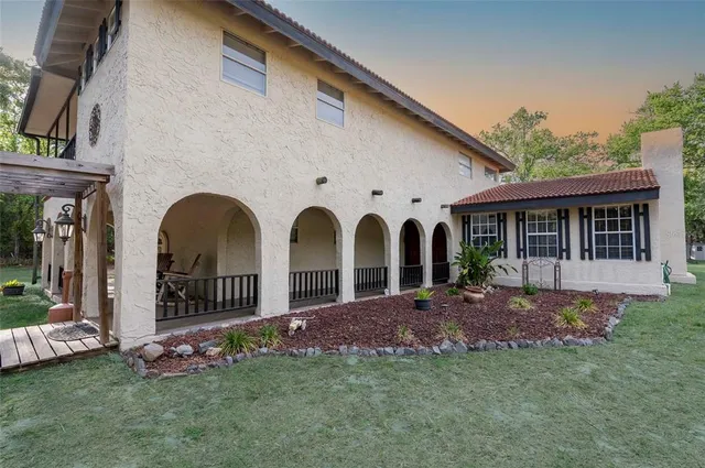 a view of a swimming pool with an outdoor seating and a yard