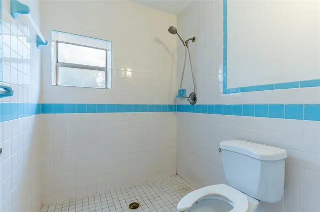 a bathroom with a tub sink and shower