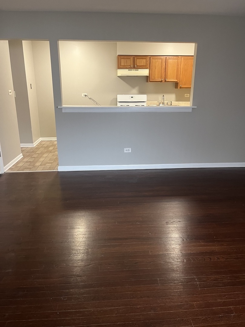 8817 South Roberts Road, Unit 11 Hickory Hills, IL 60457 - Photo 3 of 7 a view of wooden floor and windows in a room