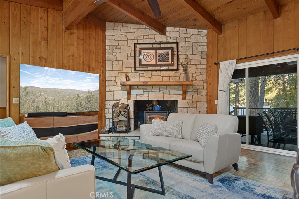 31466 Frontier Drive Running Springs, CA 92382 - Photo 15 of 43 a living room with furniture a flat screen tv and a fireplace