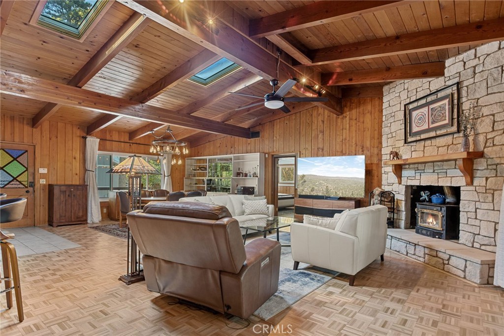 31466 Frontier Drive Running Springs, CA 92382 - Photo 17 of 43 a living room with furniture a fireplace and a flat screen tv