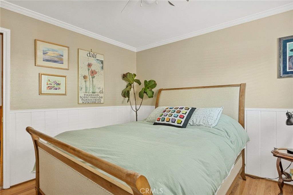 31466 Frontier Drive Running Springs, CA 92382 - Photo 28 of 43 a bedroom with a bed and painting on the wall