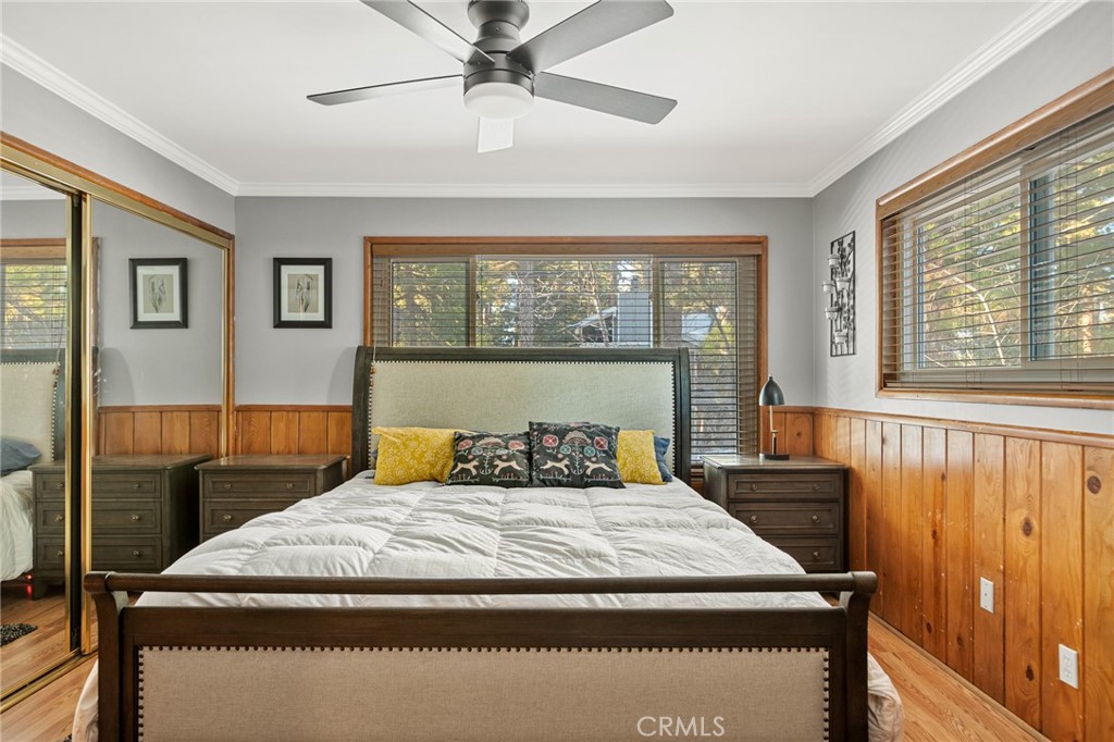 31466 Frontier Drive Running Springs, CA 92382 - Photo 32 of 43 a bedroom with a bed and wooden floor