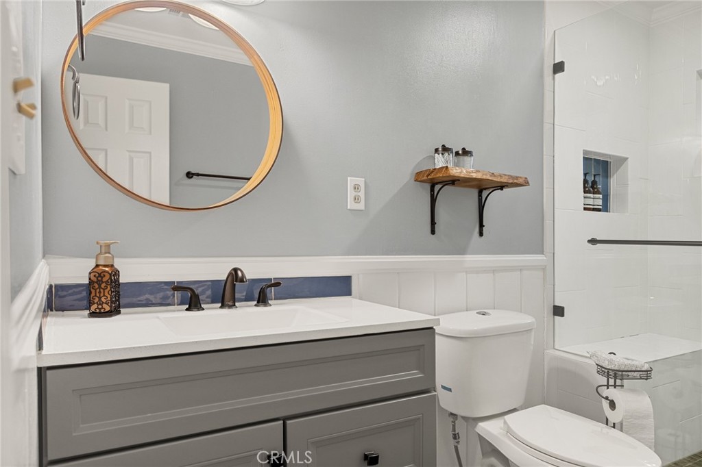 31466 Frontier Drive Running Springs, CA 92382 - Photo 35 of 43 a bathroom with a sink a mirror and a toilet