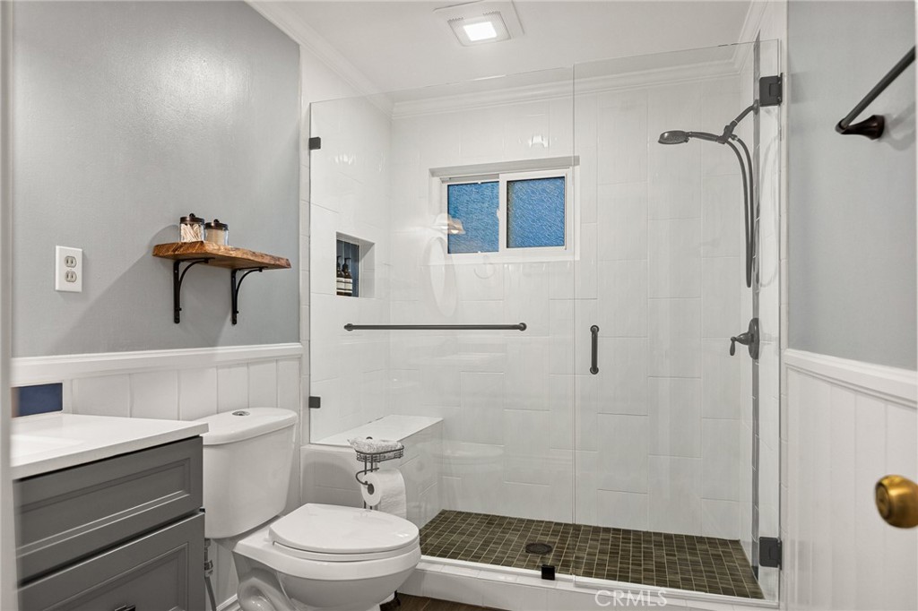 31466 Frontier Drive Running Springs, CA 92382 - Photo 36 of 43 a bathroom with a toilet a sink and shower