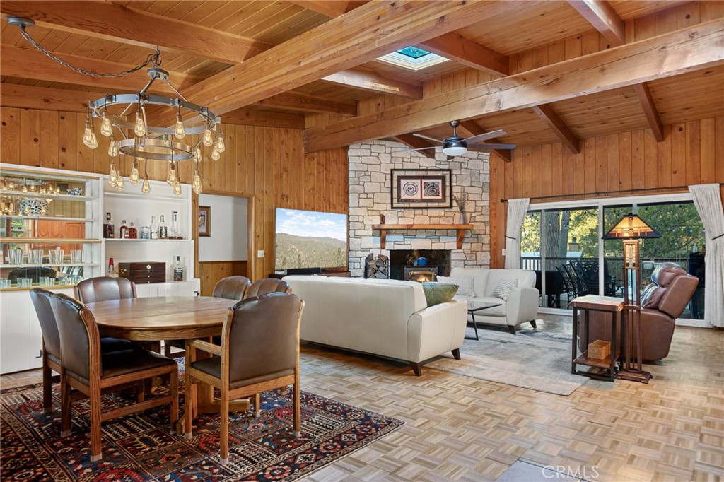 31466 Frontier Drive Running Springs, CA 92382 - Photo 8 of 43 a living room with furniture a fireplace and a table