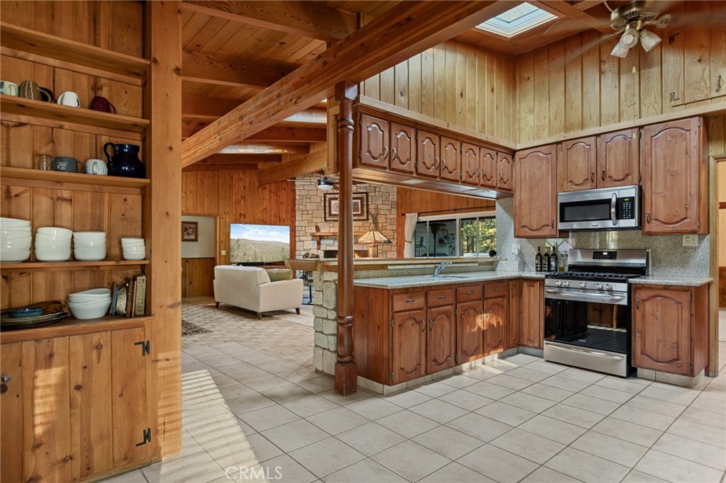 31466 Frontier Drive Running Springs, CA 92382 - Photo 10 of 43 a kitchen with stainless steel appliances granite countertop a sink and cabinets