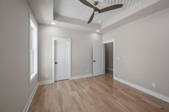 a view of an empty room with wooden floor