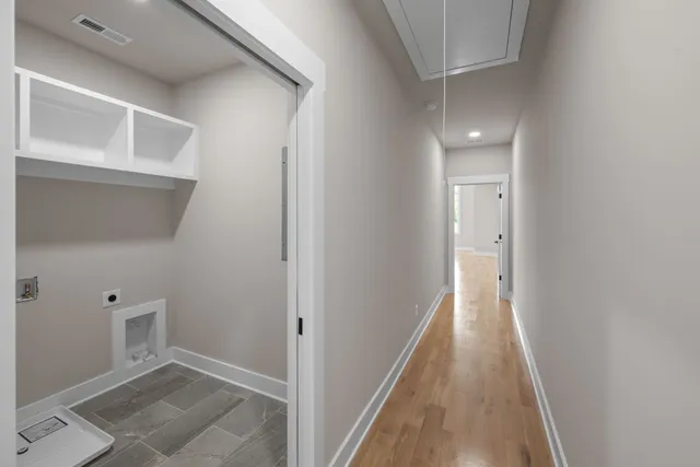 a view of a hallway with wooden floor and entryway